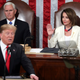 Speaker of the House Nancy Pelosi, D-Calif., raises her hand in a gesture to quiet the Democrats as President Donald Trump delivers his State of the Union address to a joint session of Congress on Capitol Hill in Washington, as Vice President Mike Pence watches, Tuesday, Feb. 5, 2019.